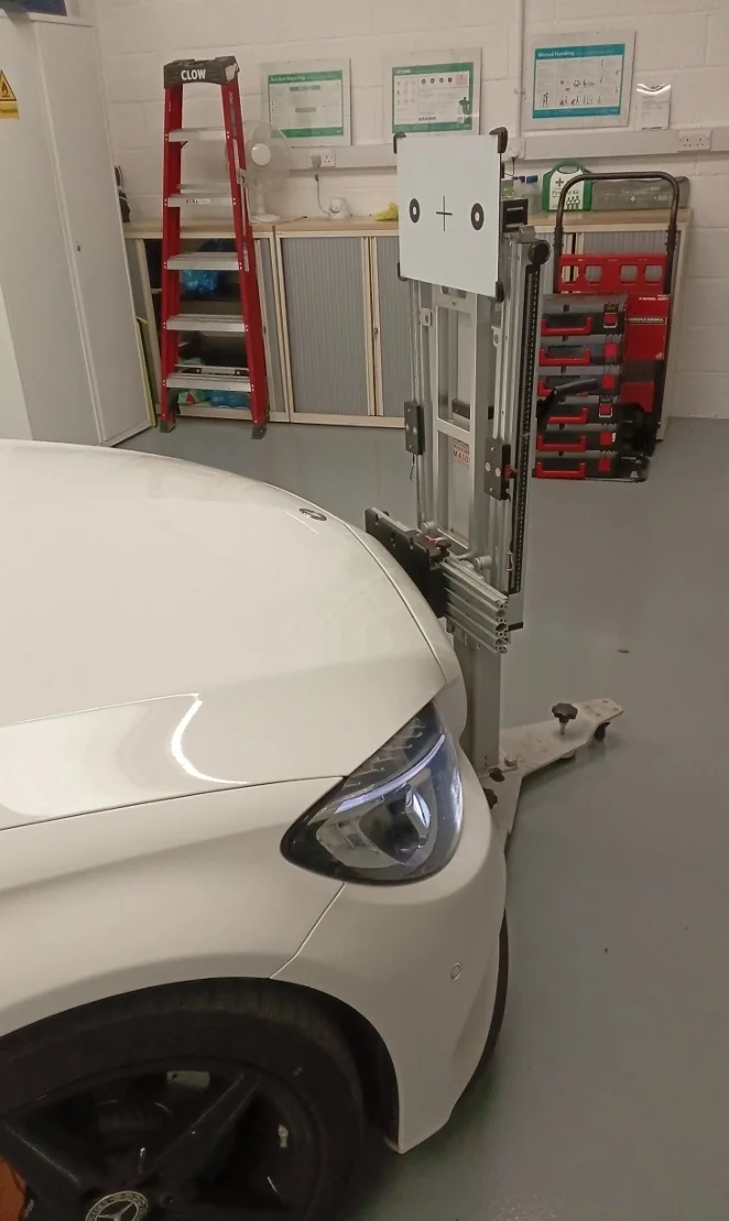 ADAS calibration technician using OEM-grade diagnostic equipment in a US service center
